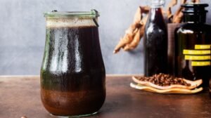 A glass pitcher of cold brew coffee sits on a modern kitchen counter.