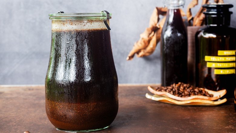 A glass pitcher of cold brew coffee sits on a modern kitchen counter.