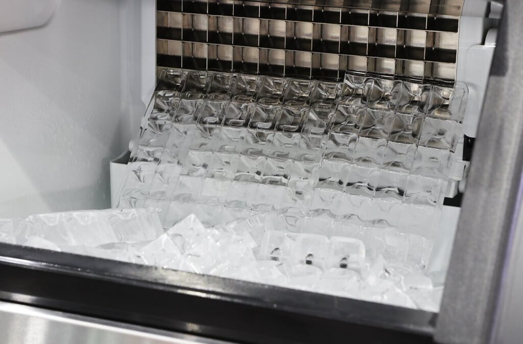 A modern commercial ice machine filled with fresh ice in a professional kitchen.