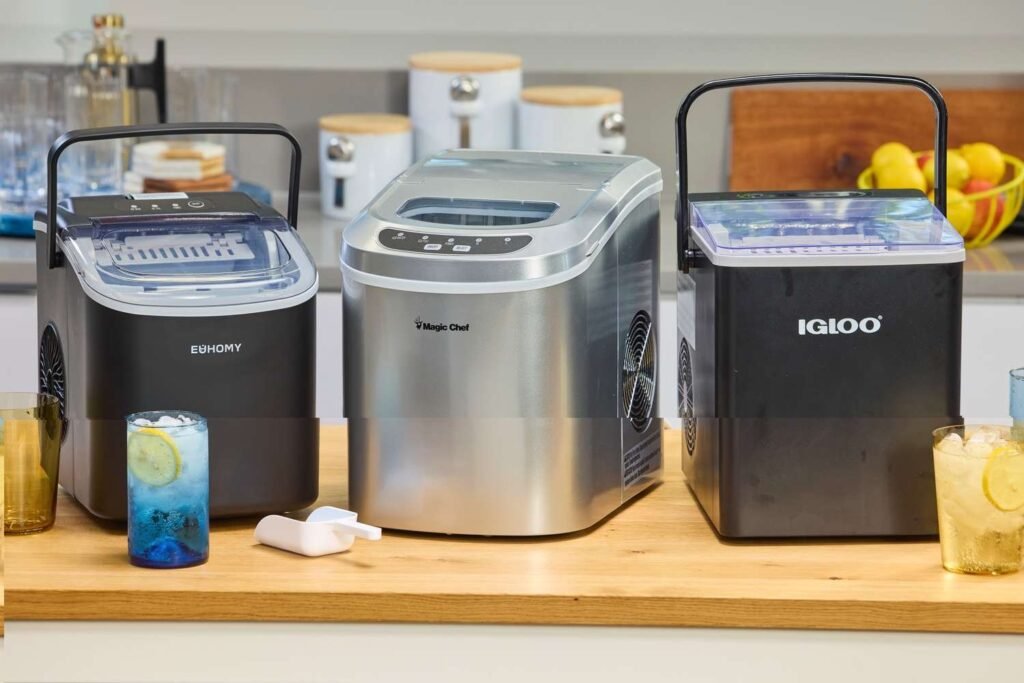 A modern countertop ice maker sits on a kitchen island with fresh ice.