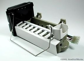Internal components of a freezer ice maker including the water valve and mold.