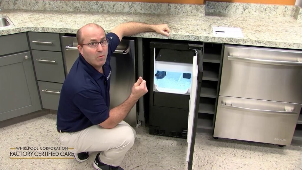 A modern undercounter ice maker integrated into a clean and bright residential kitchen.