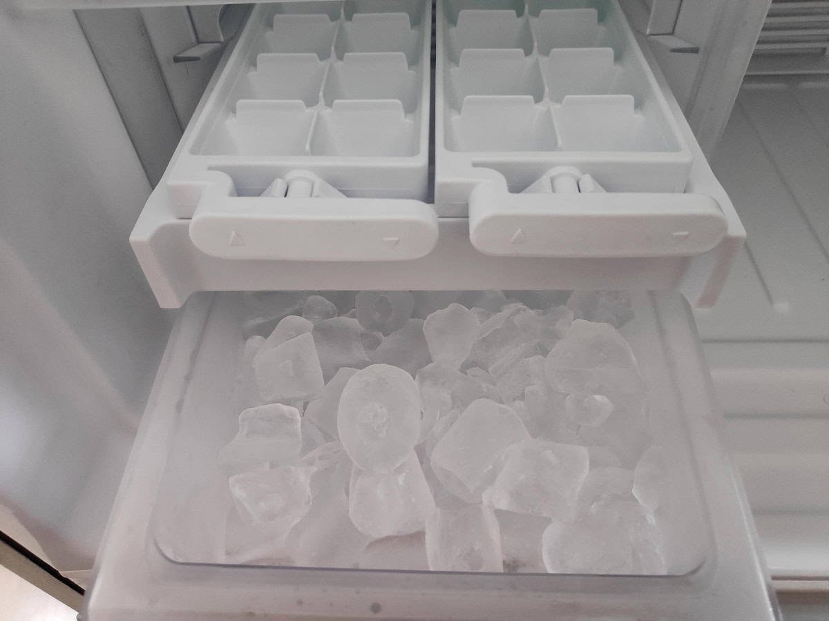 A person checking the freezer temperature to ensure the icemaker works efficiently.