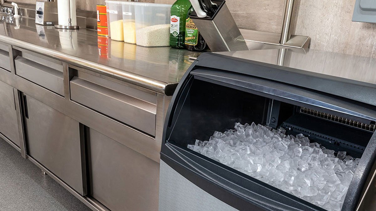 A person reviewing technical specifications next to a commercial ice machine.