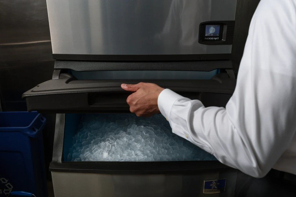 Two different types of ice machines displayed in a clean showroom environment.