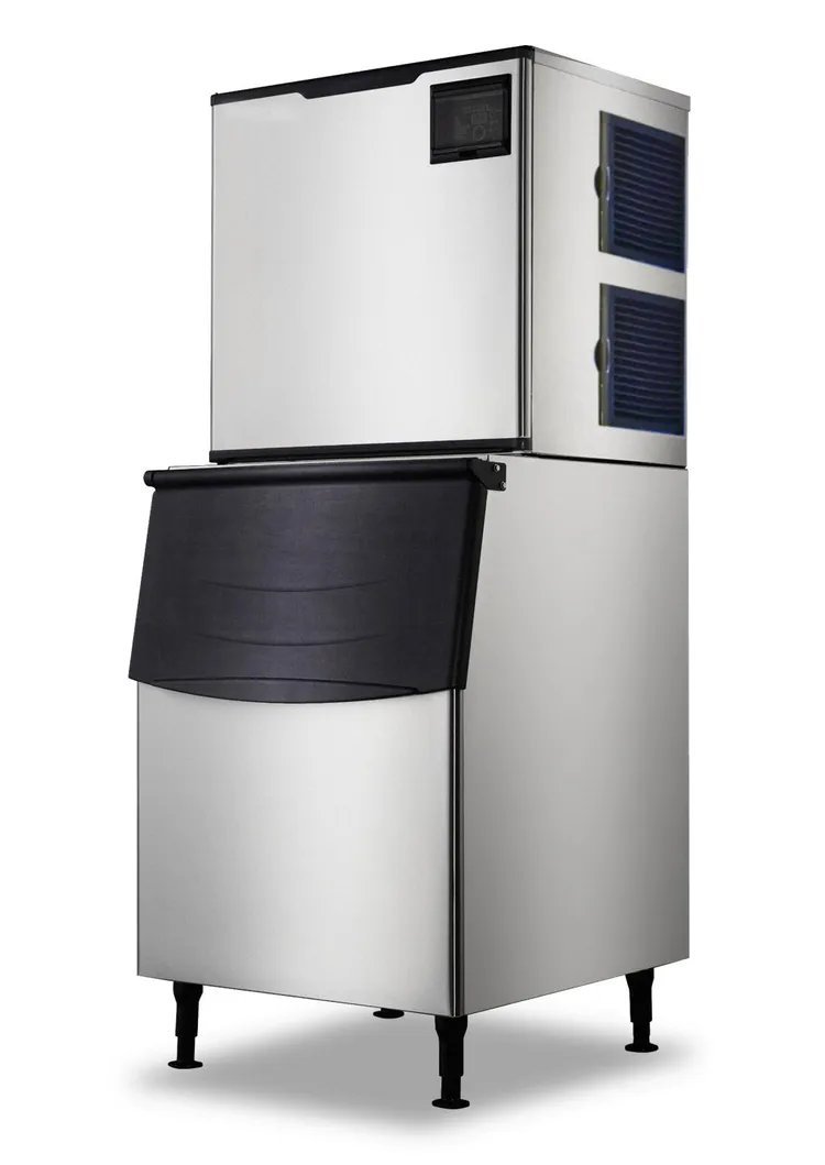 An ice maker machine operating on a kitchen counter with a timer nearby.