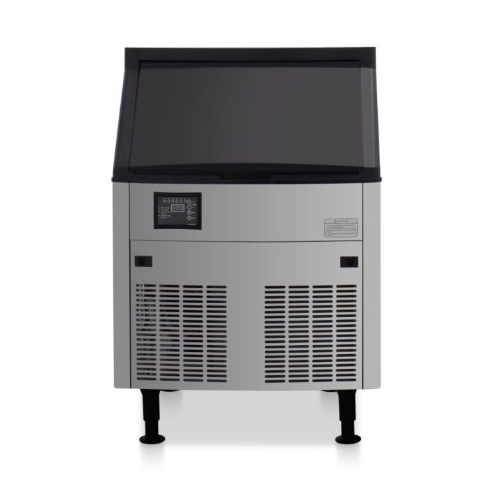 A commercial ice machine placed with adequate surrounding space for proper kitchen ventilation.