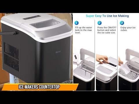 A modern countertop ice maker sits on a kitchen counter next to a pitcher.