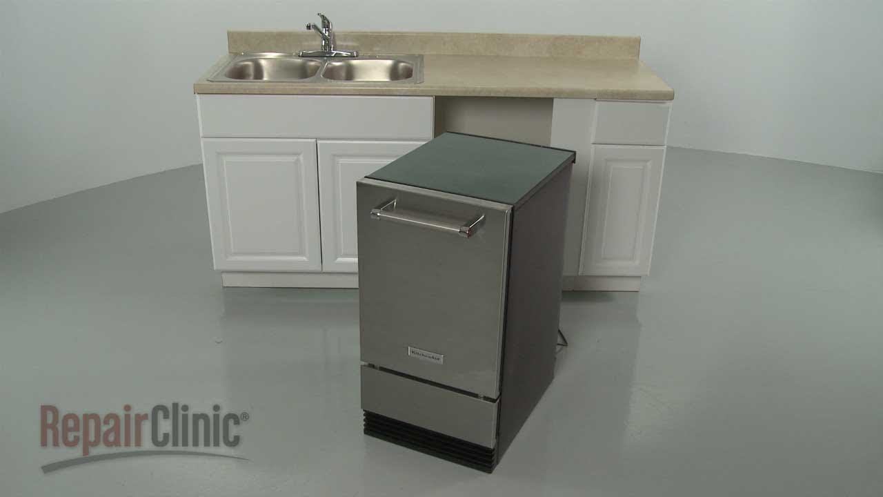 Essential tools for installing an under-counter ice maker arranged on a countertop.