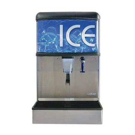 A person carefully pours water into an ice maker tray to manually fill it.