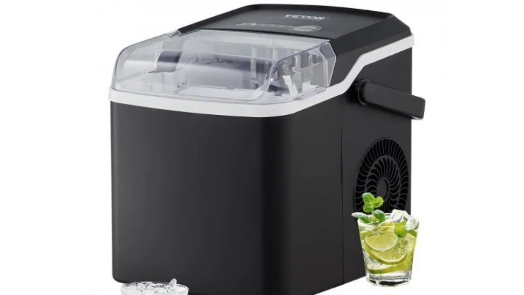 A modern ice maker placed on a wooden counter next to a water glass.