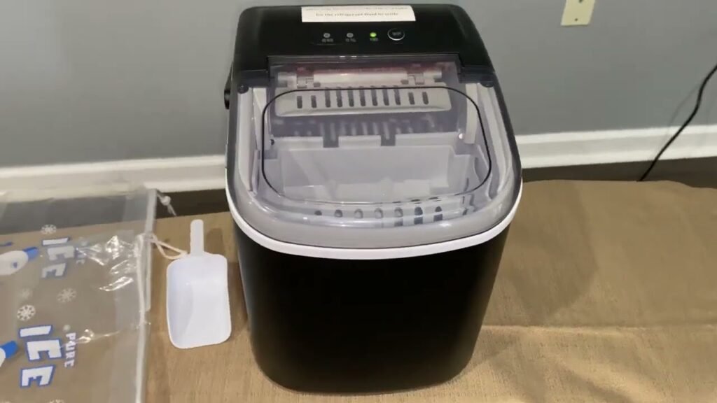 A modern refrigerator with a glass of fresh ice cubes on a kitchen counter.