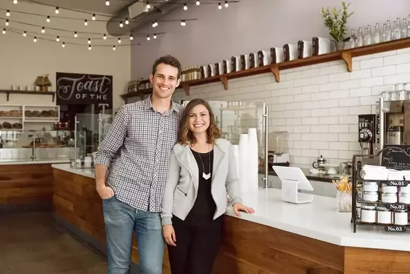The interior of a clean, modern coffee shop with a professional espresso machine.