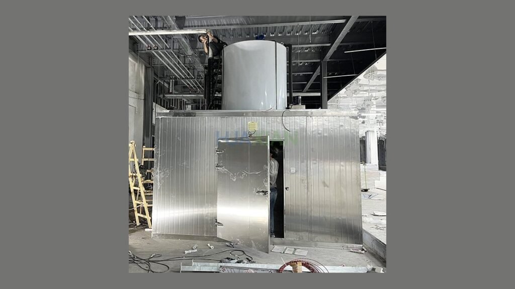 The internal mechanical components of a professional flake ice machine in a kitchen.