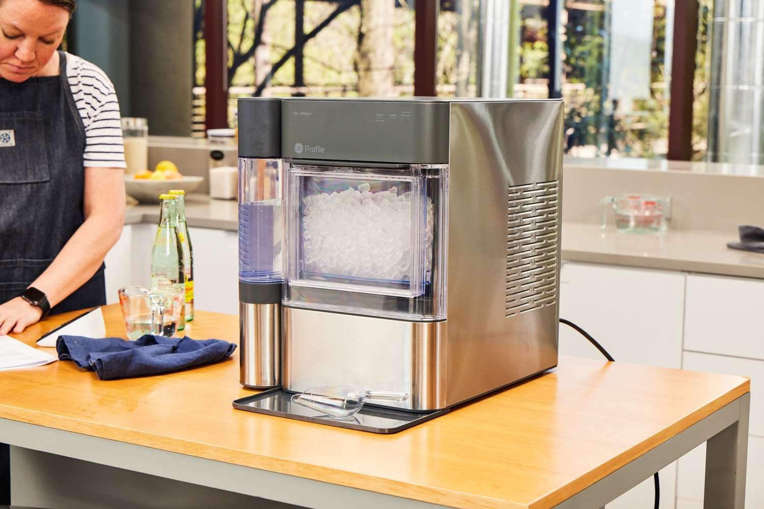 A stainless steel ice maker on a clean kitchen counter.