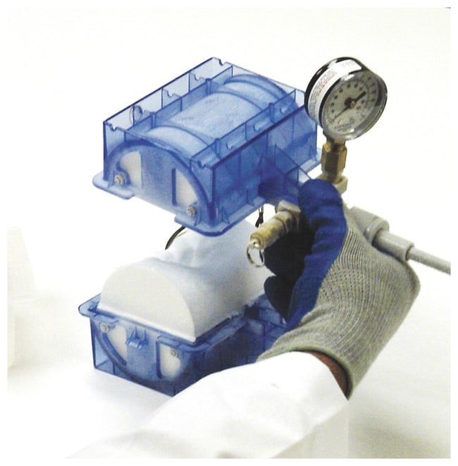 A compact ice maker on a kitchen counter being measured for proper installation fit.
