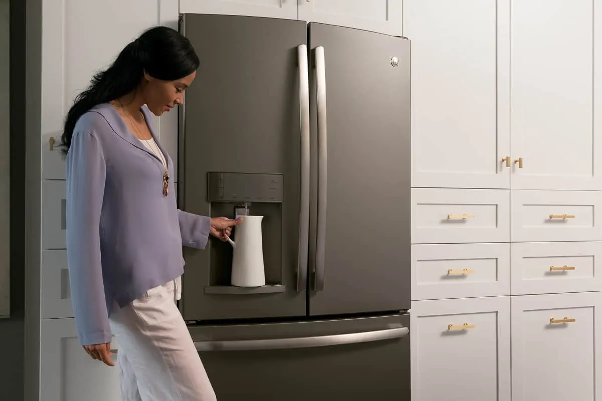 Digital thermometer beside a frosty inactive refrigerator ice maker unit