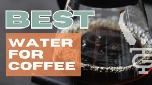 Glass carafe of filtered water beside ceramic drip coffee brewer on oak countertop