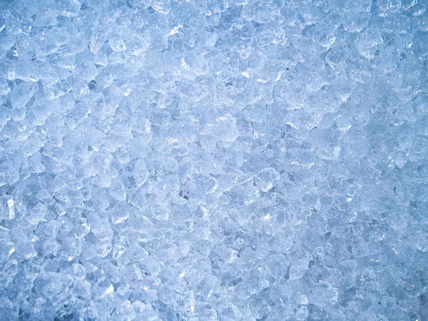 Large coolers of nugget ice wait on a loading dock for delivery.