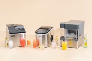 A modern countertop ice machine on a marble island preparing fresh nugget ice.