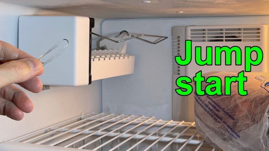 Open freezer drawer showing a built-in ice maker with fresh ice cubes.