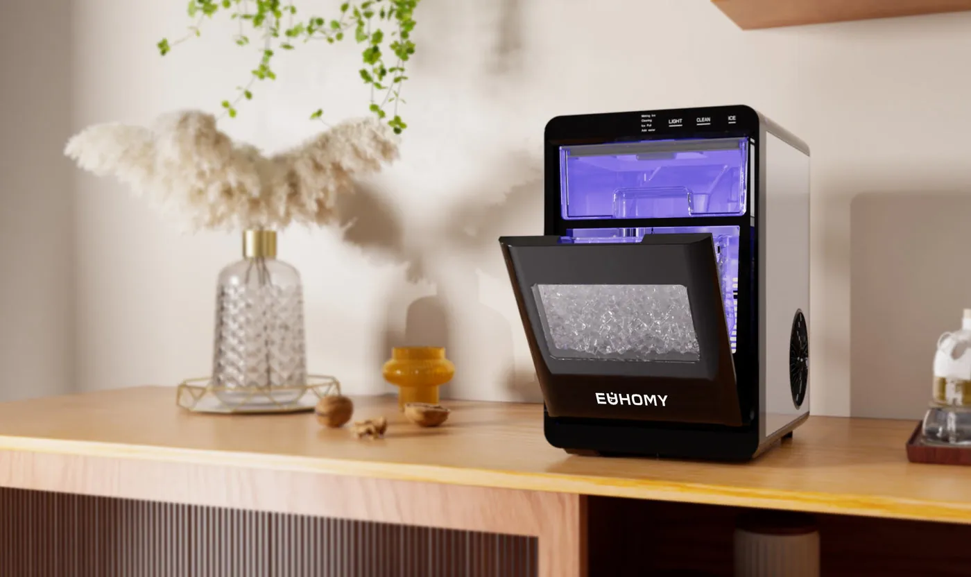 A portable ice maker sitting on a kitchen counter with fresh ice cubes.